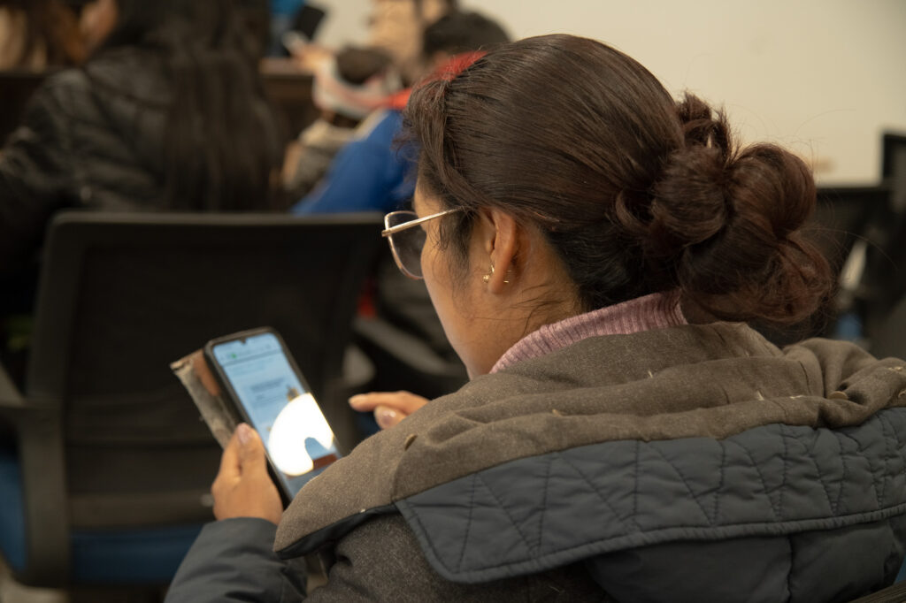 Indian woman reading a suspicious message on her phone — the moment before fraud strikes